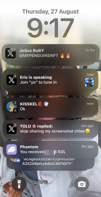 An iPhone lock screen notification overlay on Thursday, 27 August at 9:17, displaying various app notifications including Twitter/X messages, a 'Phantom' crypto wallet alert for β SOL, and a Discord notification.