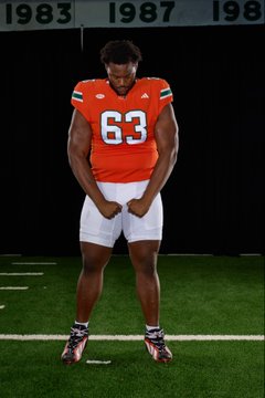 A muscular football player wearing jersey number 63 in an orange uniform stands on a field, with championship year banners (1983, 1987, 198) visible in the background—fitting the "#PANCAKEHONCHO" hashtag, which celebrates a dominant offensive lineman known for delivering pancake blocks.