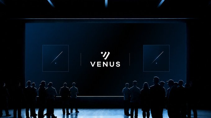 A stage is illuminated in deep blue, showcasing the "VENUS" logo flanked by abstract square designs, while silhouettes of an audience gather below in anticipation.

The image captures the dramatic reveal of Venus's upcoming announcement, with the dimly lit, onlooker-filled stage mirroring the teased "something new is coming" message about their institutional-grade RWA vault launching tomorrow on BNB Chain.