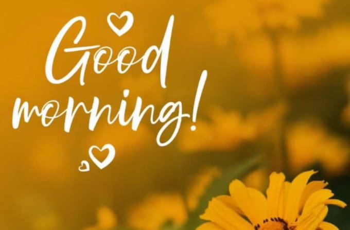 A cheerful 'Good morning!' greeting card featuring white script text with heart accents against a warm orange background of blurred yellow flowers.
