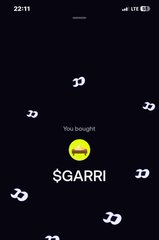 A mobile screen displays a transaction notification confirming a purchase of the cryptocurrency token $GARRI, accompanied by animated dollar signs on a dark background.