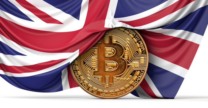 A golden Bitcoin coin is displayed in front of a draped Union Jack flag, symbolizing the UK Parliament's new inquiry into traditional banks restricting crypto firms and blocking crypto-related accounts and transactions.