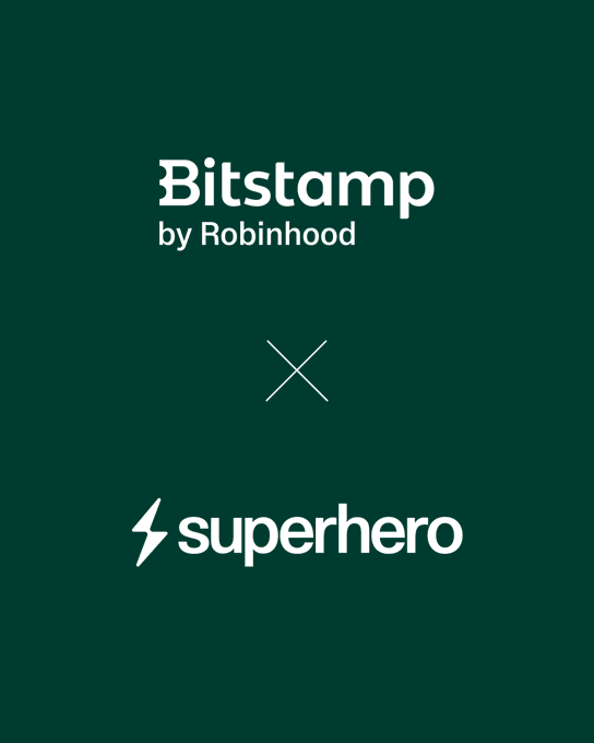 A dark green graphic displays "Bitstamp by Robinhood" at the top, an "X" symbol in the middle, and "superhero" (accompanied by a lightning bolt logo) at the bottom, visually representing the partnership between the two platforms.
