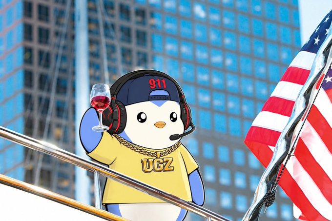 A cartoon penguin character wearing a '911' cap, gold 'UGZ' chain, yellow shirt, and headphones with a microphone, holding a glass of red wine next to an American flag with skyscrapers in the background.