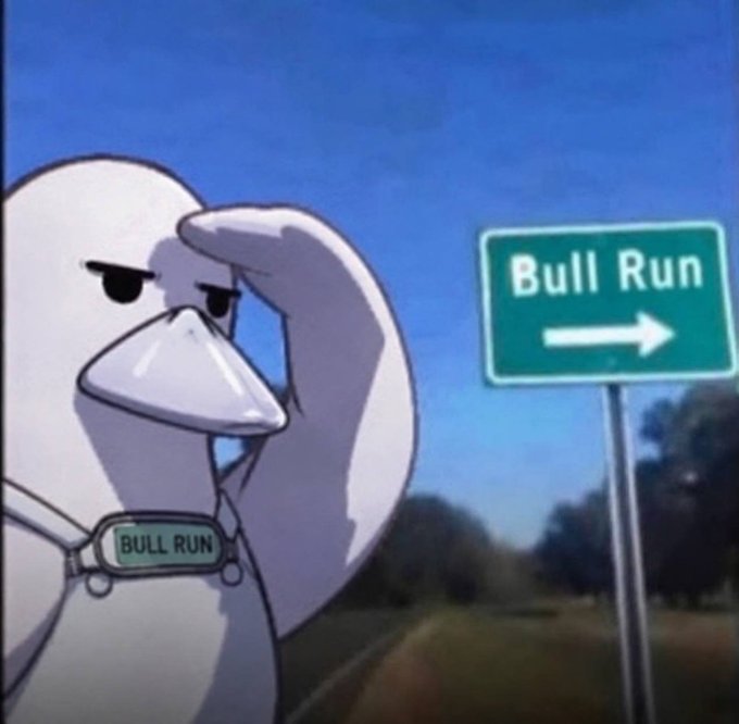 A cartoon goose, wearing a "BULL RUN" dog tag, stands at a crossroads next to a green sign reading "Bull Run" with a right-pointing arrow, gazing confidently ahead as if deciding which way to go.

The image humorously personifies the "Bull Run" market signal, with the goose ready to run toward bullish gains in line with the "UPtober" optimism expressed in the post.