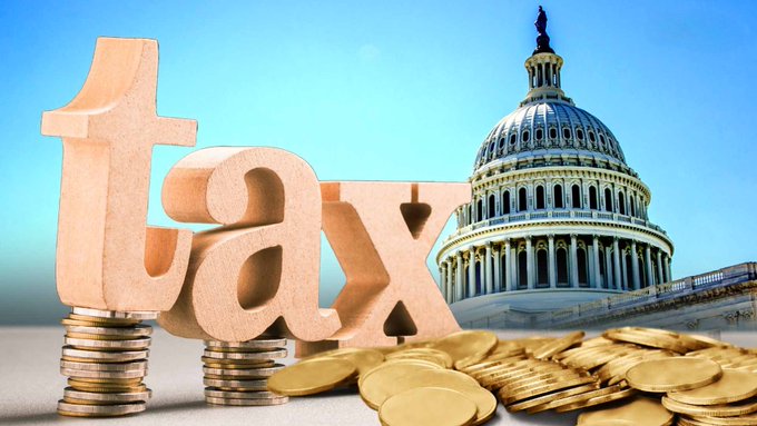 3D illustration of the word 'tax' displayed on stacks of coins with the U.S. Capitol building in the background, symbolizing taxation.
