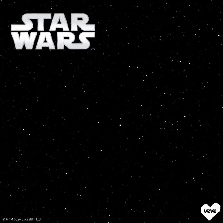 The image features a poster with the words "Star Wars" written in white letters against a black background, surrounded by stars. The poster also includes a heart symbol at the bottom right corner. Below the poster, there's a text that reads "@veve.sjv.io/InsideFandom This is the way!".