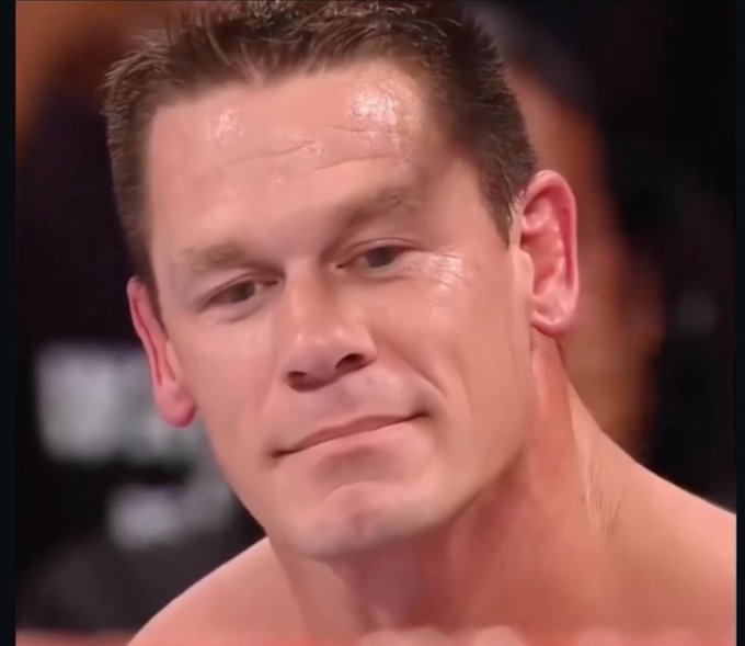 A close-up portrait shows a sweating, shirtless man with short hair looking downward with a serious expression.