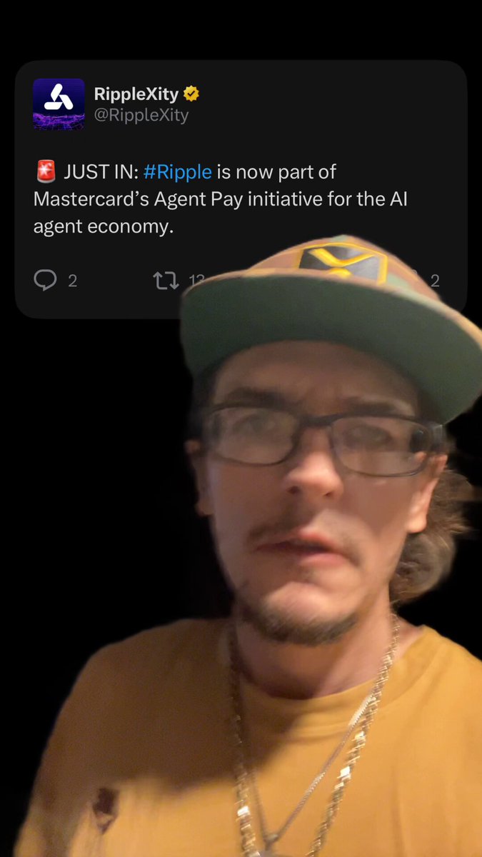 The image features a man wearing glasses, a yellow shirt, and a green hat with his face partially visible. He has a beard and is looking directly at the camera. The caption of the image reads "XRP Got the AI brain". This phrase seems to be related to the post about RippleXr, which was shared on Twitter by a user named @riplexty.