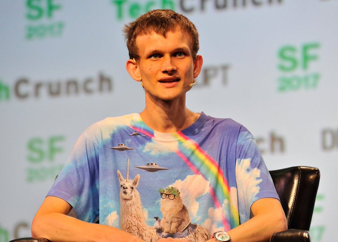 Vitalik Buterin, Ethereum creator, sits on a panel at 'TechCrunch SF 2017' wearing a colorful t-shirt featuring llamas and UFOs.