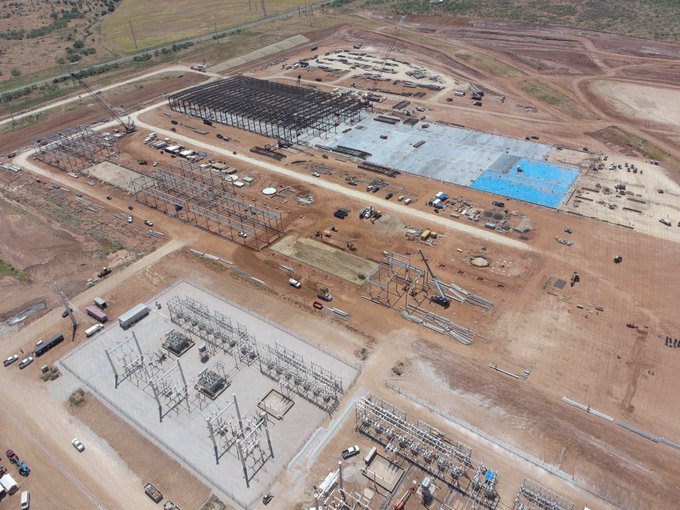 An aerial view of a large-scale construction site showing the steel framework and foundation work for what appears to be an industrial facility, likely a data center or energy infrastructure project. The image supports the post's bullish sentiment about $IREN (Iris Energy), suggesting significant physical expansion and development activity for the company.