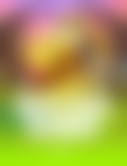 A heavily blurred, unrecognizable image featuring soft patches of green, brown, yellow, and pink, likely a slot game scene intentionally obscured to invite viewers to guess which game it is in the comments.