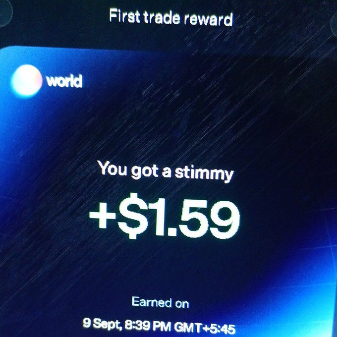 The image displays a 'First trade reward' notification from the 'world' app, announcing a 'stimmy' payout of +$1.59 earned on September 9th at 8:39 PM GMT+5:45.