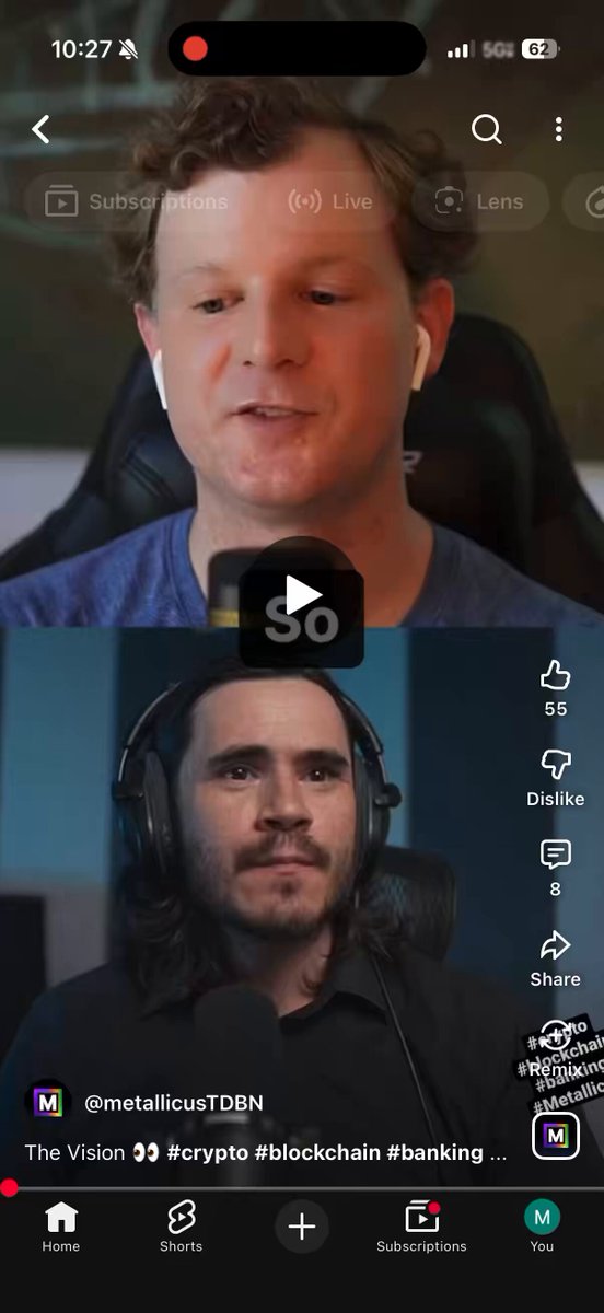 The image shows a cell phone screen with two men's faces, one of whom appears to be wearing headphones. The man on the left side of the screen has his face partially visible behind the other man who is wearing headphones. Both men are looking at each other and appear to be engaged in conversation or watching something together.