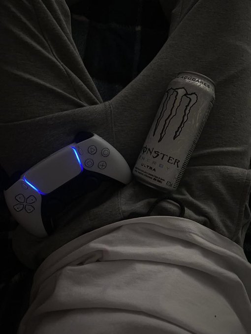 A Monster Energy Ultra can sits beside an illuminated PlayStation 5 DualSense controller on a gray hoodie, capturing a relaxed gaming morning—fittingly paired with the caption "Good Morning Legends Manifesting wins for us all."