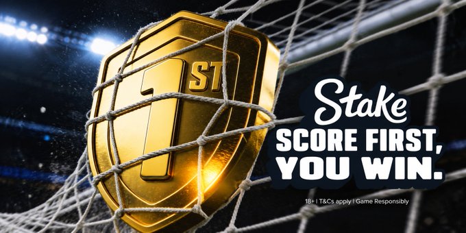 A golden shield emblem featuring "ST" is shown in a soccer net inside a stadium, alongside the "Stake" logo and the tagline "SCORE FIRST, YOU WIN," with an 18+ responsible gambling notice. The image serves as a paid promotion linking the gambling brand to a $50 $SOL giveaway tied to a sports/soccer match outcome.