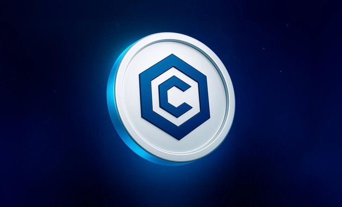 A glowing Cronos (CRO) token emblem floats against a dark blue cosmic background, featuring the chain's signature blue and white hexagonal logo design. The image visually represents the cryptocurrency mentioned in the post, emphasizing its brand identity during a minor price pullback.