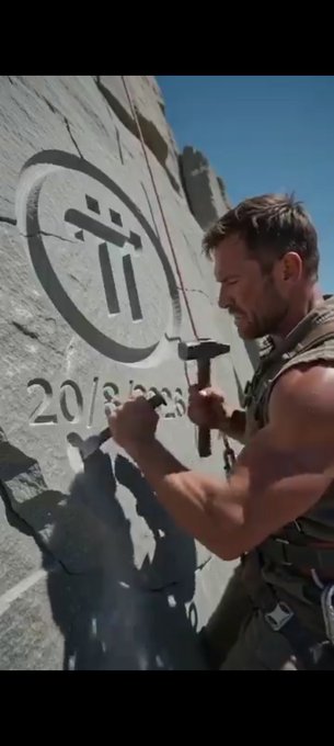 A man chips away at stone to carve the Impractical Jokers logo with a date that begins '20/8/2023'.