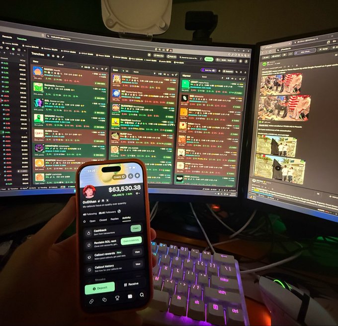 A person holds a smartphone displaying a crypto portfolio with a $63,530.38 balance under the name "Oxlithuan," alongside dual monitors showing trading charts and news, symbolizing a lone retail trader's pursuit of financial dreams. The setup visually reinforces the "One man, One wallet, One dream" mantra through the solitary focus on a personal crypto holding.