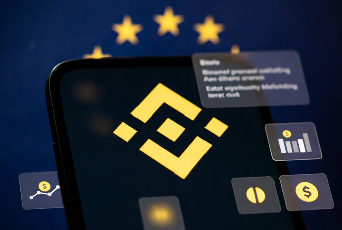 The image shows a smartphone displaying the yellow Binance logo against a blurred European Union flag background, surrounded by floating digital interface elements including charts, a dollar sign icon, and notification boxes. The image visually reinforces the post's content about Binance restricting certain services in the EU due to its incomplete MiCA (Markets in Crypto-Assets) license compliance.