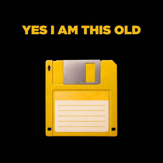 A graphic showing a yellow floppy disk on a black background, with the text "YES I AM THIS OLD" displayed in yellow above it.