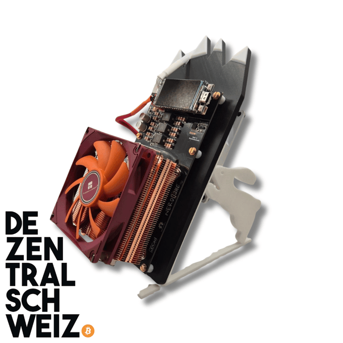 A graphics card with a small orange cooling fan mounted on a black heatsink, with the text 'DE ZEN TRAL SCH WEIZ' and a Bitcoin logo in the corner.