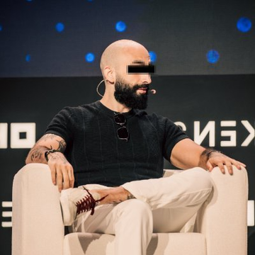 The image features a bald man wearing sunglasses, sitting in a chair with his legs crossed. He has a microphone attached to his ear, suggesting that he might be participating in an event or speaking at a gathering. The background of the image shows a black wall with white dots on it and the words "SOLANA" written on it. The post caption reads: "JUST IN:  ANYBODY IN THE WORLD WITH AN INTERNET CONNECTION CANOWN THE HOTTEST STOCK ON EARTH WITH NOTHING BUT A SOLANA KEYPPAIR THAT'S INTERNET CAPITAL MARKETS."