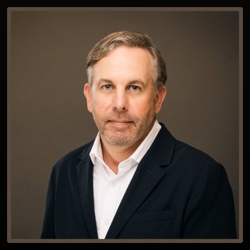 A professional headshot of Bart Smith, CEO of Avalanche Treasury, dressed in a dark blazer and white shirt against a neutral background, accompanying his commentary on blockchain block space constraints amid rising AI agent activity.