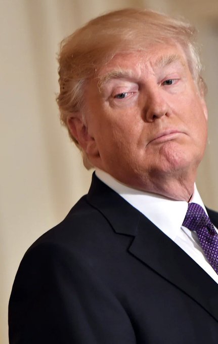 A man with blonde hair wearing a dark suit and purple tie looks off to the side with a serious expression, appearing to represent former President Trump whose investment in Intel ($INTC) is highlighted in the accompanying post about profitable market opportunities.