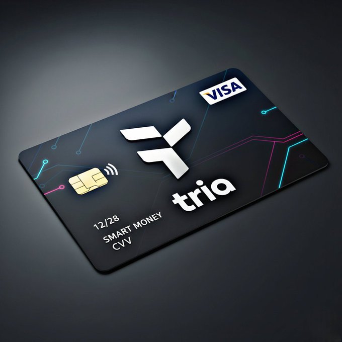 The image features a black credit card from Tria, which has a unique design that includes a white logo of a bird with its wings spread out. The credit card is placed against a gray background, making it stand out prominently. The text on the credit card reads "Tria Smart Money", indicating that the card offers smart money management features and benefits for users.