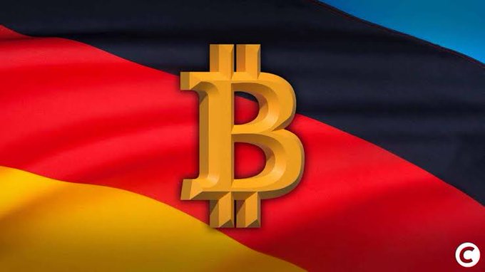 A golden Bitcoin symbol is prominently displayed over the waving German flag (black, red, and yellow), symbolizing Germany's potential reconsideration of its long-term cryptocurrency tax exemption currently under review.