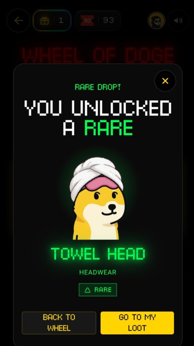 A dark game screen displays “RARE DROP,” “YOU UNLOCKED A RARE,” and “TOWEL HEAD HEADWEAR,” featuring a cartoon dog wearing a towel, with buttons for “BACK TO WHEEL” and “GO TO MY LOOT.”