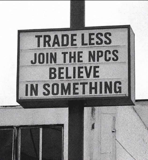 The image features a sign with black and white text against the backdrop of a building or storefront, which reads "Trade Less, join the NPC believe in something". The sign appears to be from the past, possibly during an earlier time when there was more focus on bitcoin trading and crypto assets like NPC.