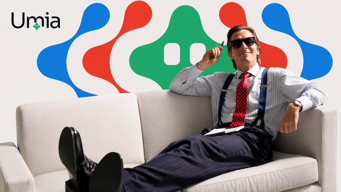 A man in a striped shirt, red tie, suspenders, and sunglasses reclining on a white couch in front of a colorful abstract logo and the text 'Umia'.