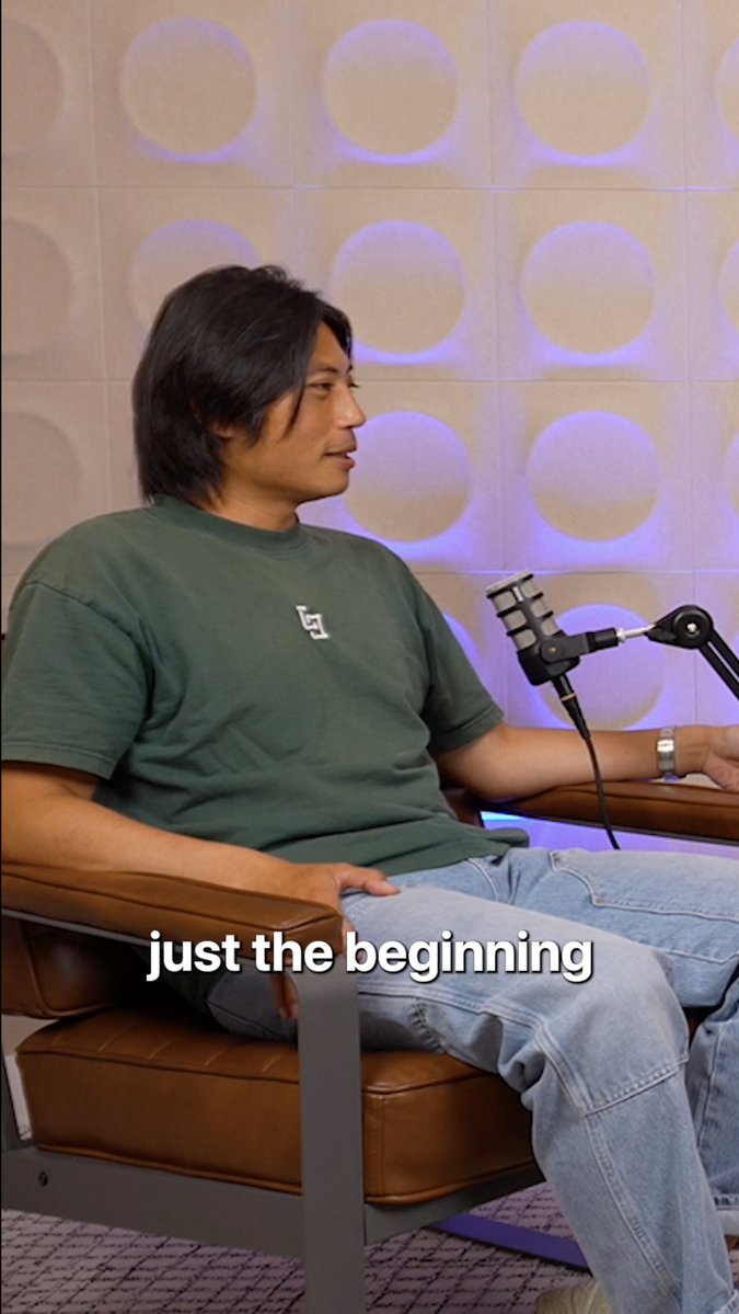 A man in a green t-shirt sits in a brown leather chair in front of a microphone in a podcast studio with circular patterned walls, with the caption "just the beginning" displayed below.

The image relates to the post about @term_labs CEO @dionchu discussing how raising capital is just the beginning of a founder's journey, and that real success comes from identifying what isn't working and finding new solutions—a conversation captured during this podcast recording.