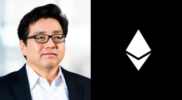 In this image, a man wearing glasses and a suit stands next to an identical image of another man's face wearing a white shirt with black lettering. They are both smiling for the camera. The text in the image seems unrelated to the main content, such as "WHALE WATCH: Big money is quietly absorbing the Ethereum supply. Tom Lee and Bitmine just picked up another 75000 $ETH from Kraken and FalconX. That is 123 million dollars moved off exchanges in only 8 hours. Institutions are aggressively buying these levels. Are you". This text does not provide any relevant information to the main subject of the image - a man in glasses and a suit.