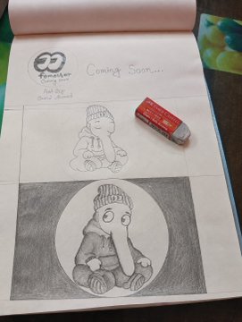 A sketchbook showing pencil drawings of a character in winter clothing with a 'Coming Soon...' label and a Tommy Hilfiger eraser resting on the page.
