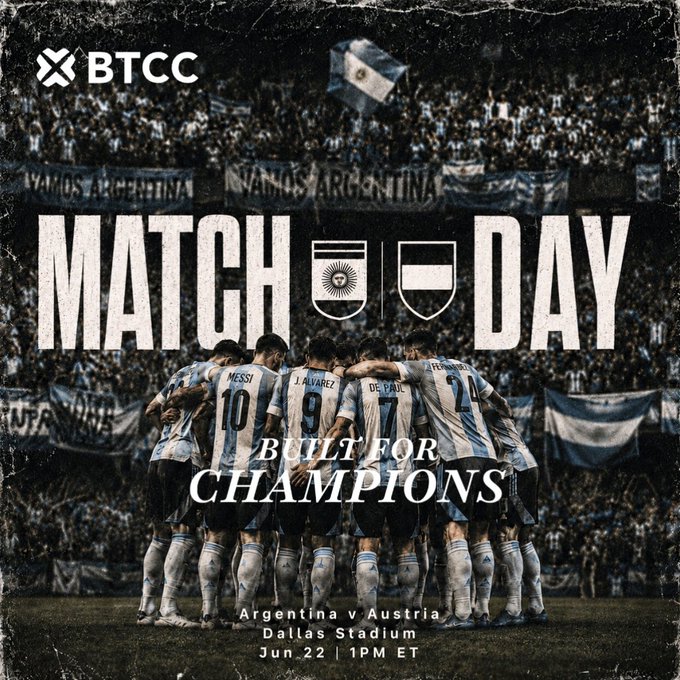 The image shows a soccer match between Argentina and Austria, with the soccer players standing around each other as part of their team huddle. In the background, there are people watching the game from behind a fence, indicating that this could be a professional or high-level tournament event. The text in the image appears to be promotional for Match Day, which is a worldwide soccer match day.