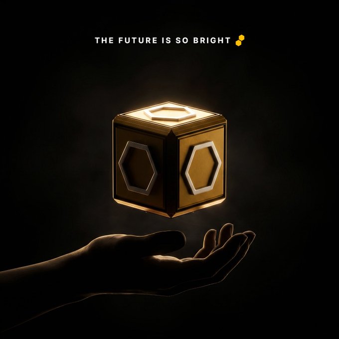 A dark promotional image featuring a glowing golden cube floating above an outstretched hand, with the text 'THE FUTURE IS SO BRIGHT' at the top.