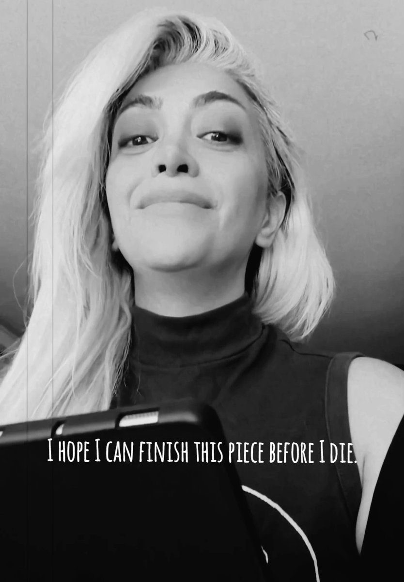 Black-and-white selfie of a blonde woman wearing a black turtleneck with a tablet/phone in front of her, featuring the text overlay 'I HOPE I CAN FINISH THIS PIECE BEFORE I DIE.'