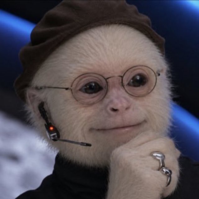 A digitally altered or AI-generated image of a white monkey wearing a brown beret, round wire-rimmed glasses, and a black turtleneck, posed with its hand near its chin.