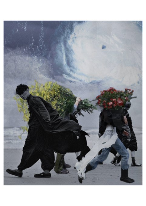 A surreal fashion photograph shows figures in dark clothing carrying large bouquets of flowers against a backdrop of crashing ocean waves.