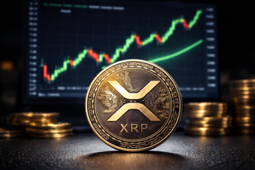 A close-up of a physical XRP cryptocurrency coin displayed in front of a screen showing an upward-trending green stock chart.