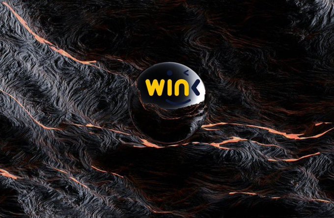 A black sphere with the word 'win' in yellow lowercase letters, set against a dark, textured, molten lava-like background.