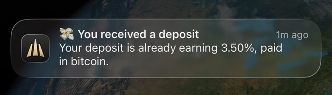 A notification stating 'You received a deposit. Your deposit is already earning 3.50%, paid in bitcoin.'