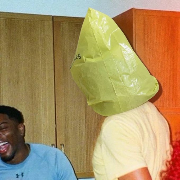 A man with a large yellow plastic bag completely covering his head stands next to a laughing friend in a blue shirt, embodying the caption's declaration that "Ansem knows. Bag stays on."