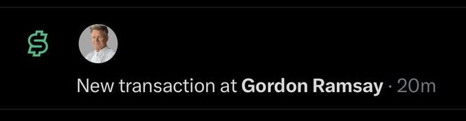 A dark-themed mobile notification showing 'New transaction at Gordon Ramsay · 20m' next to a green dollar sign icon and a profile photo.