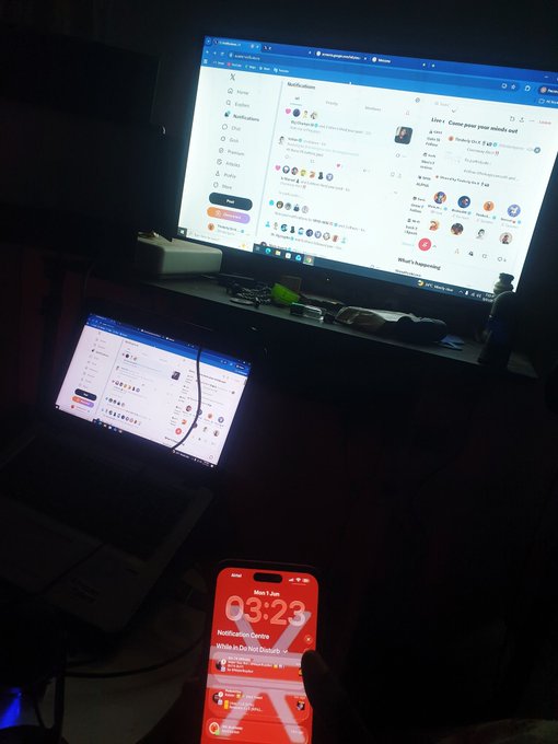 The image shows a person sitting next to two computers, one of which has an open laptop screen displaying a web browser, while another computer displays a desktop monitor showing a chat window with multiple users. The scene takes place at night, as indicated by the dark background and the presence of a TV in the room. A cell phone is also visible on the desk next to the computers.

The post seems to be about a person's interest in finding generational wealth or exploring the internet for information related to monkeys and frogs smoking pots. The image captures an interesting moment where someone is using their laptop, while another computer displays a chat window with multiple users. This could suggest that the individual is engaged in online discussions or research on this topic at night.