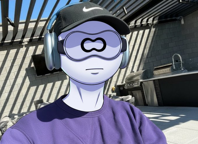 The image features a cartoon character wearing a purple shirt and a black baseball cap with a white "N" logo. The character appears to be posing for a photo or drawing, possibly at an outdoor event like a fair or festival. In the background, there is a sink and a grill, suggesting that this scene takes place in an area where people can enjoy food and other activities.