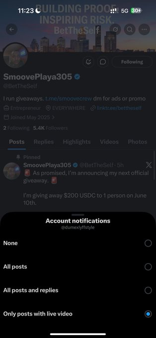 The image shows a social media app with a Twitter feed, displaying a post from SmooovePlaya. The post includes a link to a video and mentions that the account has been tagged with "@SaiyanBeats791". The post also mentions that it is a retweet of a tweet about building a business. The image focuses on the social media app's interface, highlighting its features for users who want to engage with others online or follow specific accounts.